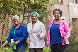 two women smiling and jogging