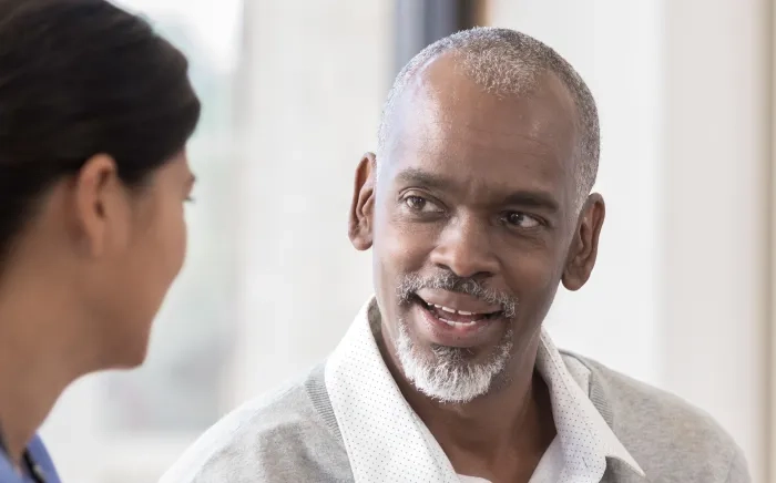 A patient and a clinician conversing.